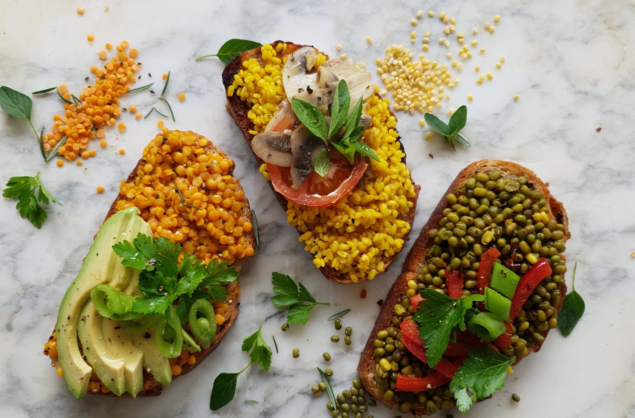 The serving suggestion shows delicious toasty's that are our healthy version of beans on toast! Yummy sourdough topped with red lentil dhal, yellow moong dhal and green moong kivtahri. Topped with fresh avocado, parsley, tomatoes, roasted mushrooms, and red peppers. Beautifully displayed on a marble table top 