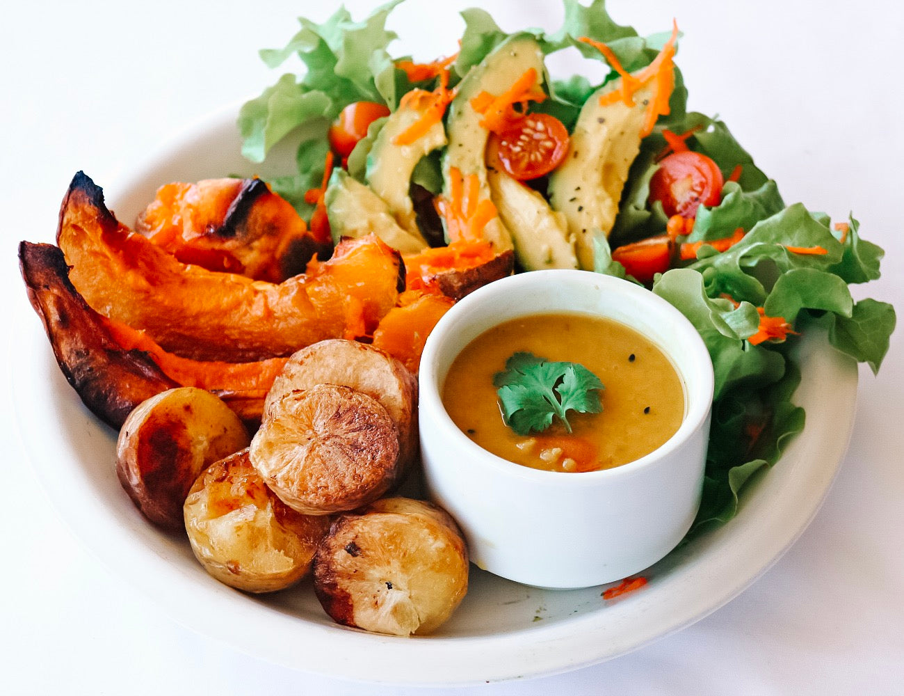 Red lentil dhal features with a simple roast veggie bake of pumpkin potatoes. served with a fresh salad of cherry tomatoes, avocado, grated carrot, buttery lettuce. Super easy and full of plant protein. vegan and gluten free and always 100% natural