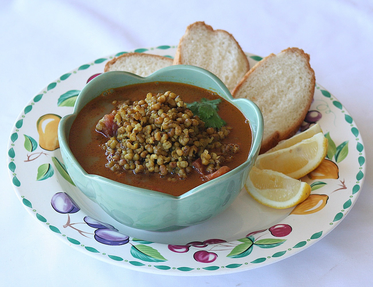 green moong dhal served with fresh crusty bread and lemon wedges